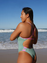 Athlete Sara wears the fixed back Lennox one piece by JAYD Swimwear in the colour Matcha with contrasting fairy floss cut outs. Swimwear designed for performance.