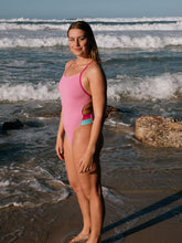 Athlete wearing the IBIZA chlorine resistant one piece designed by JAYD Swimwear. Featured colour is Fairy floss with contrasting hip cut outs. Swimsuit is built for performance