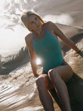 Paralympic Swimmer Keira Stephens wearing the IBIZA swimsuit made by JAYD Swimwear in the Matcha colours, suit feature contrasting straps and hip cut outs. Built for performance.