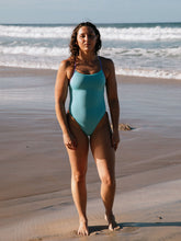 Athlete Madi wears the IBIZA fixed back one piece by JAYD Swimwear in the colour Mykonos. It features contrasting hip cut outs and full coverage.