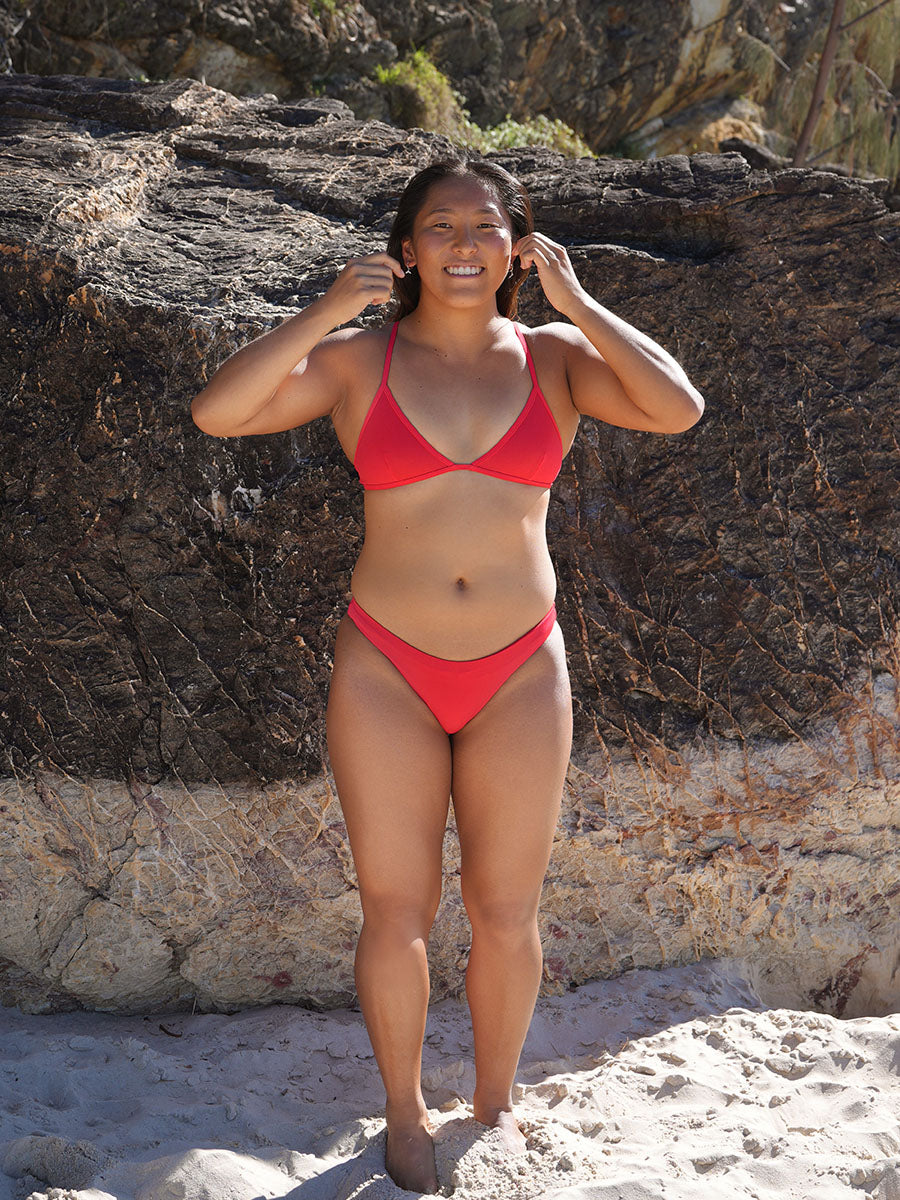 Athlete Sara wears the Kiama top by JAYD Swimwear in the colour Ruby. This top is fixed back and built for both training and beach days.