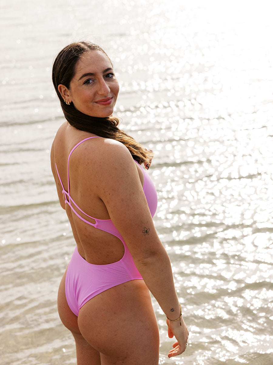 Athlete Jenaya wears the Zimmy one piece by JAYD Swimwear in the coluor Fairy Floss, this piece offers a cheeky coverage and is built for performance.