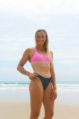 Athlete wearing full coverage black JAYD bikini bottoms called Connie. 