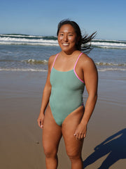 Athlete Sara wearing the fixed back chlorine resistant Lennox one piece by JAYD Swimwear in the colour Matcha with contrasting fairy floss strap detailing.