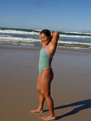 JAYD Swimwear fixed back one piece called Lennox.  Worn by athlete Sara in the Matcha colour with fairy floss straps and hip detailing. 