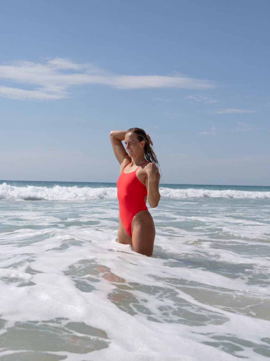 Olivia is swimming in the ocean in her JAYD Swimwear, Zimmy one piece in Fiesta colour.