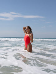 Olivia is swimming in the ocean in her JAYD Swimwear, Zimmy one piece in Fiesta colour.