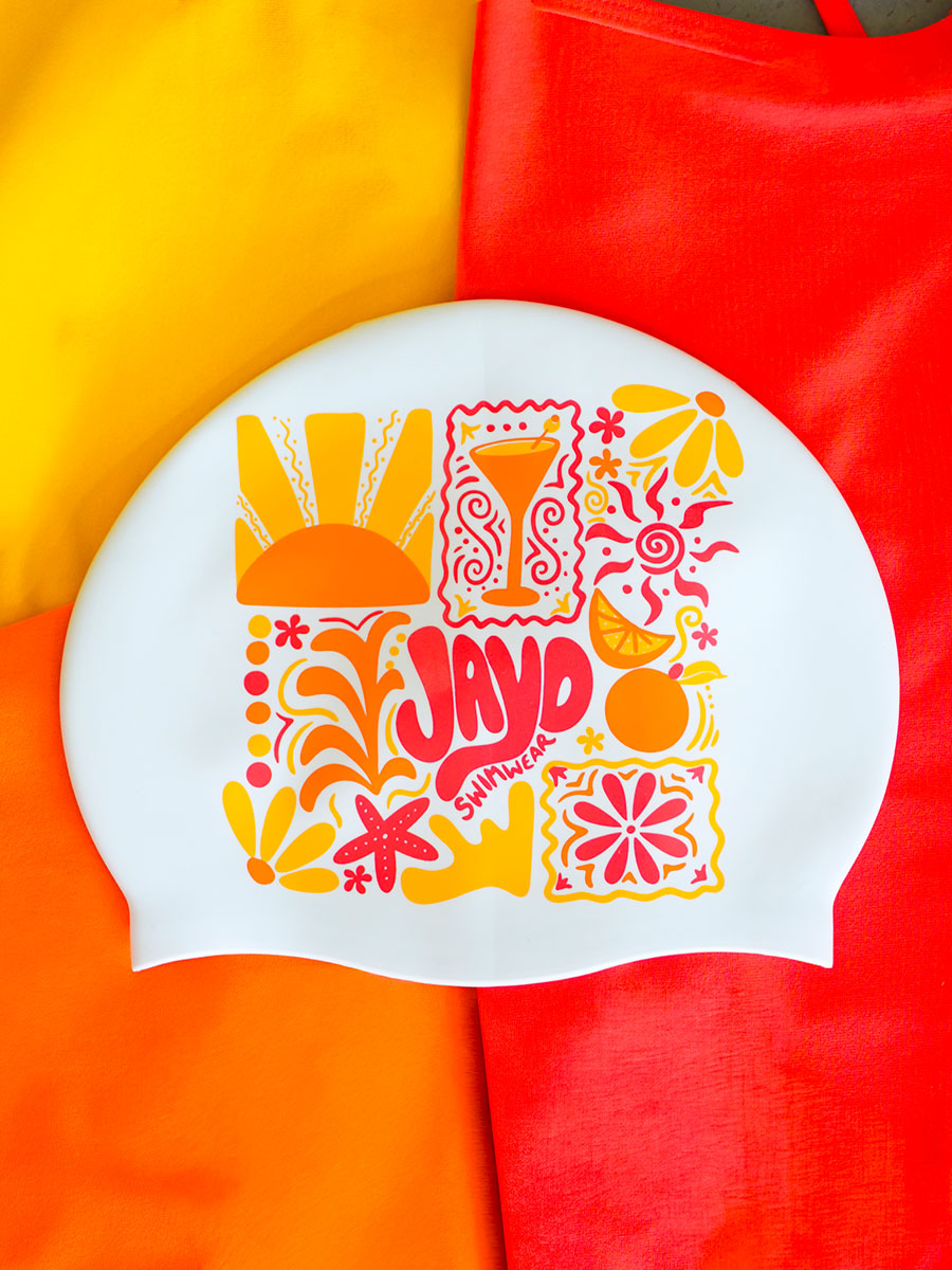 Colourful swim cap with floral and abstract designs on a multicoloured background