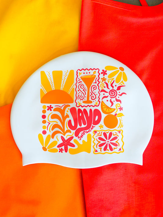 Colourful swim cap with floral and abstract designs on a multicoloured background